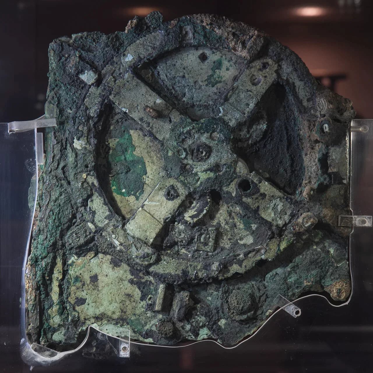 Corroded bronze Fragment A mounted for display, with parts of its gear train visible.