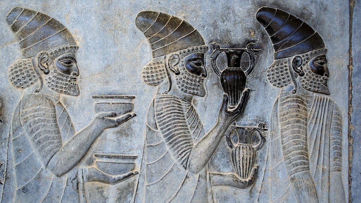 Carved figures in a procession along the Apadana staircase at Persepolis.
