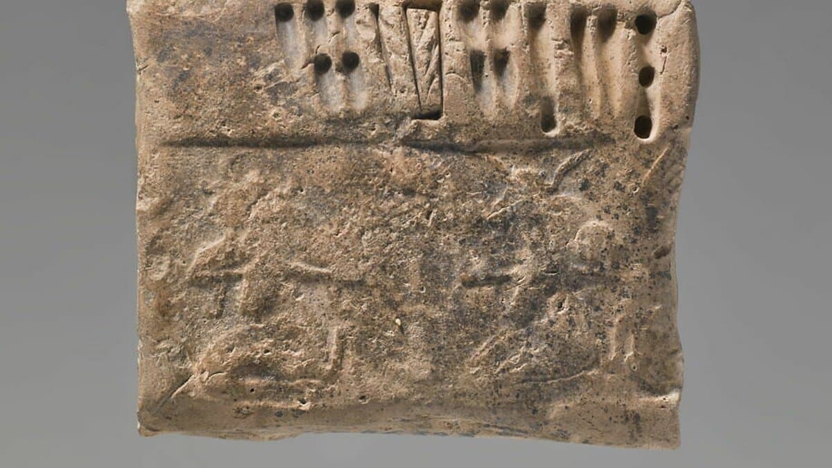 Small clay tablet bearing impressed signs and numerical marks.