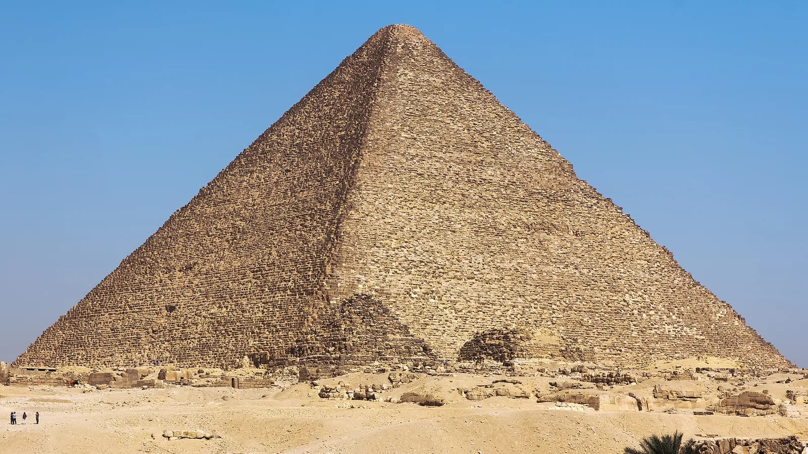 Weathered stone courses rising along the side of the Great Pyramid of Khufu at Giza.