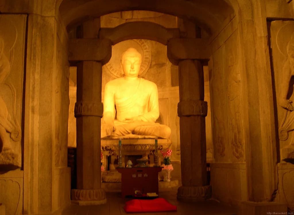 Seated stone Buddha seen through the inner chamber of Seokguram Grotto.