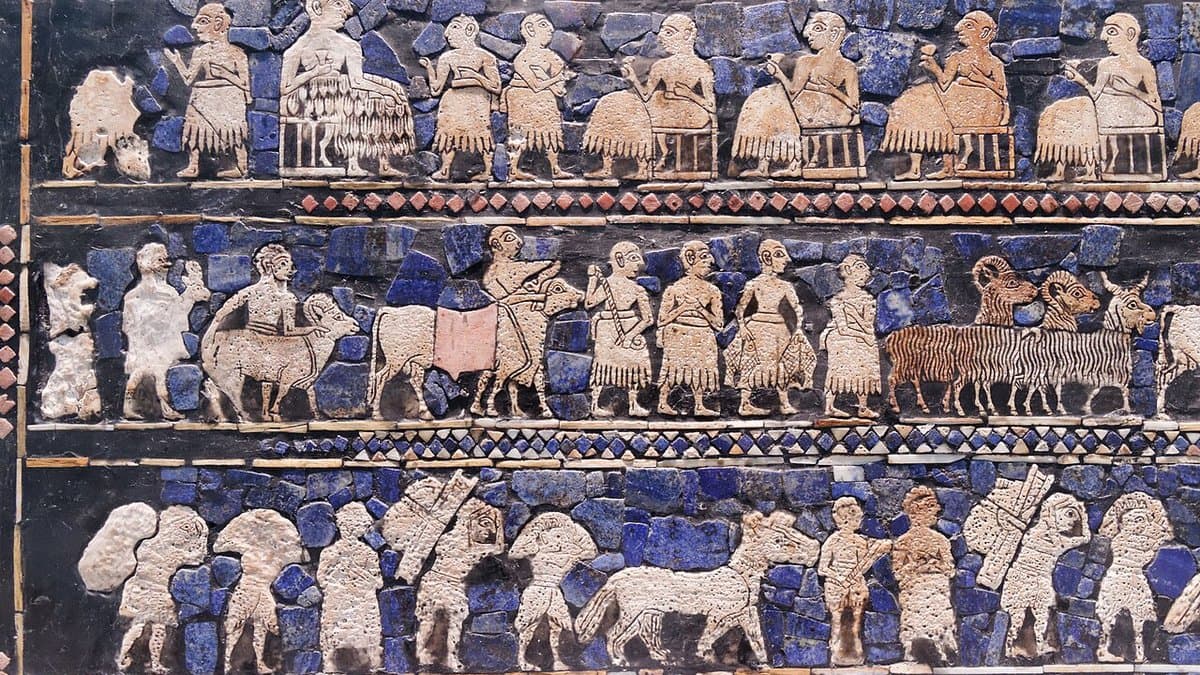Inlaid panel of the Standard of Ur showing rows of seated figures, animals and attendants in shell, lapis lazuli and red limestone.