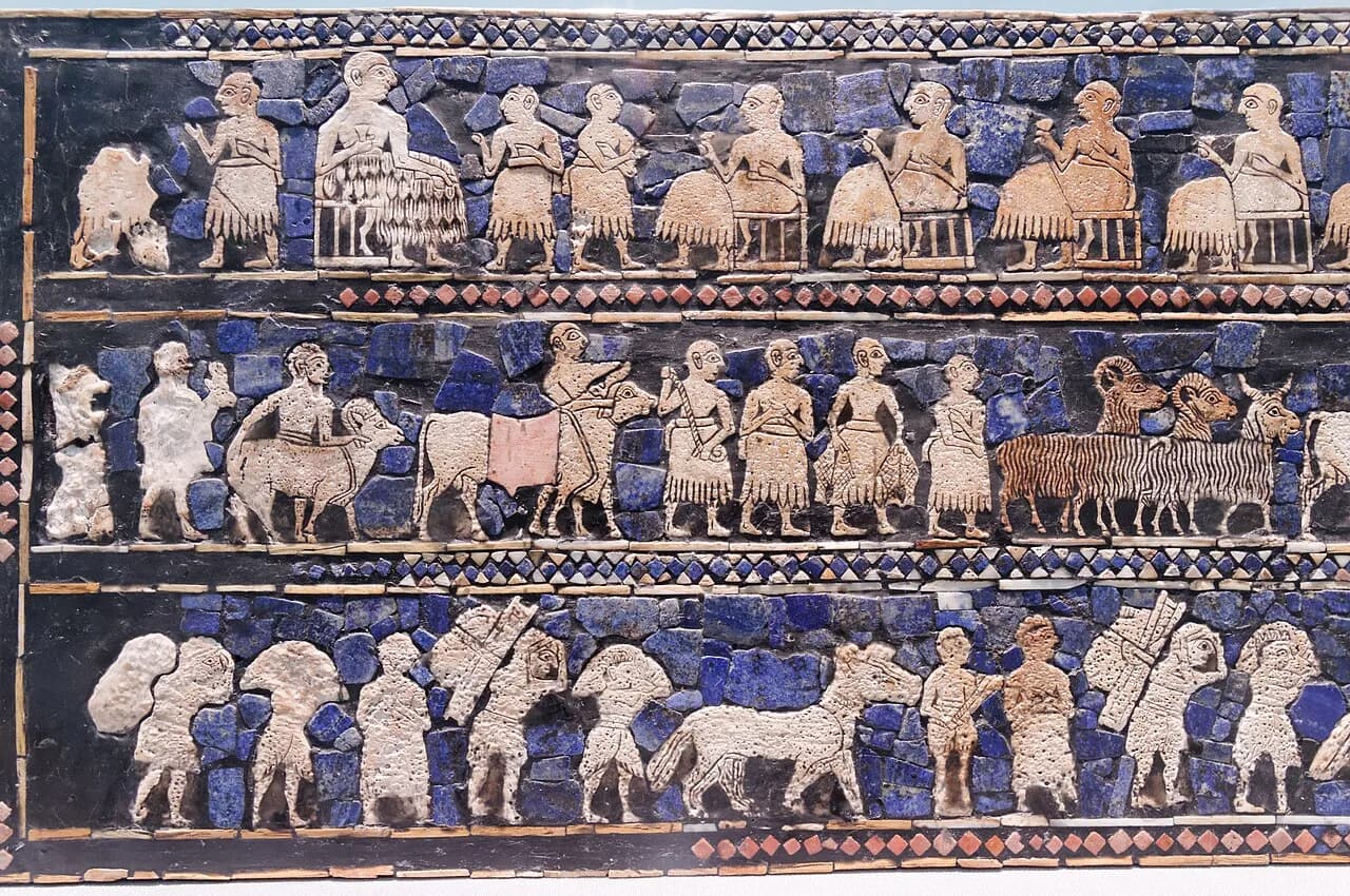 Inlaid panel of the Standard of Ur showing rows of seated figures, animals and attendants in shell, lapis lazuli and red limestone.