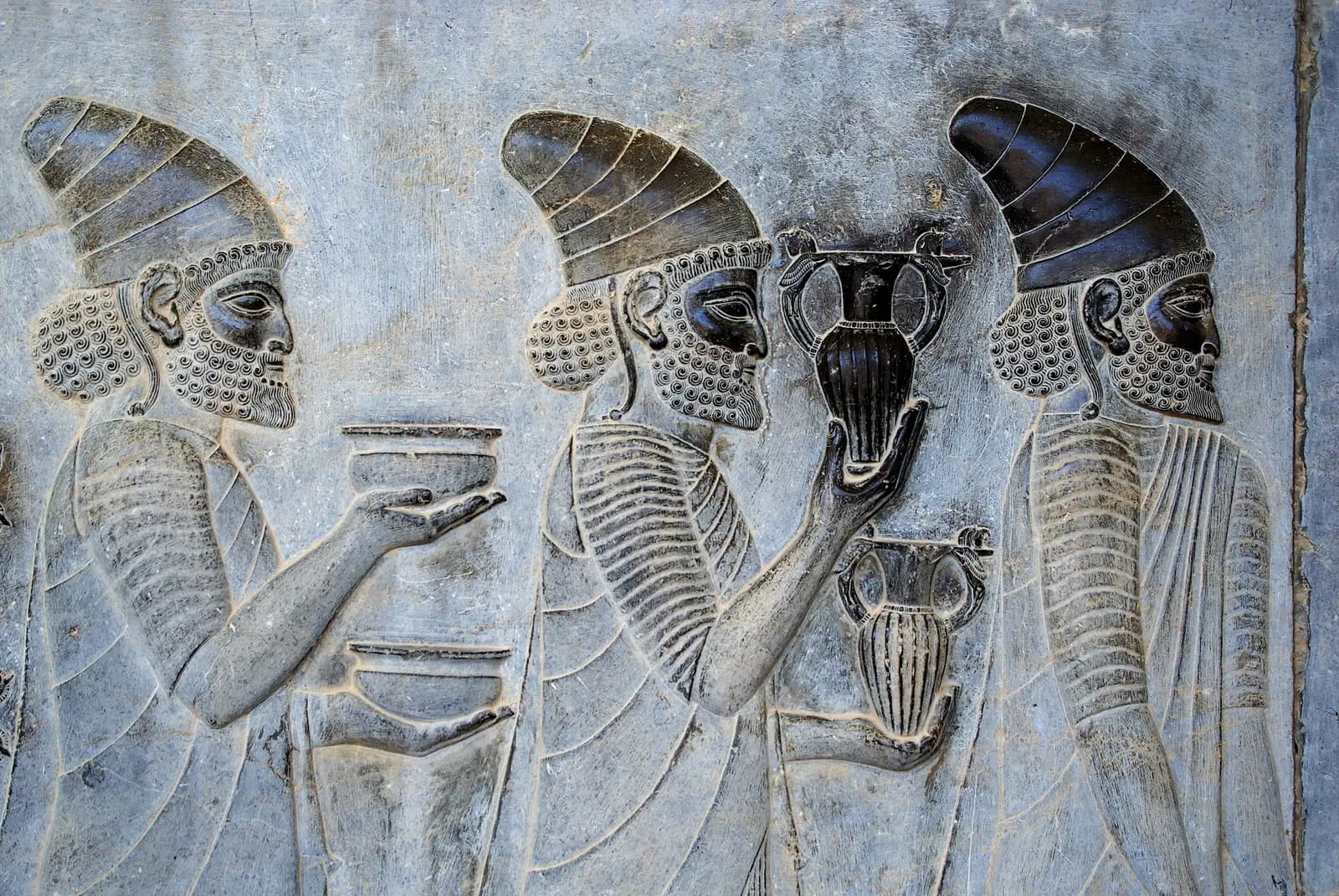 Carved figures in a procession along the Apadana staircase at Persepolis.