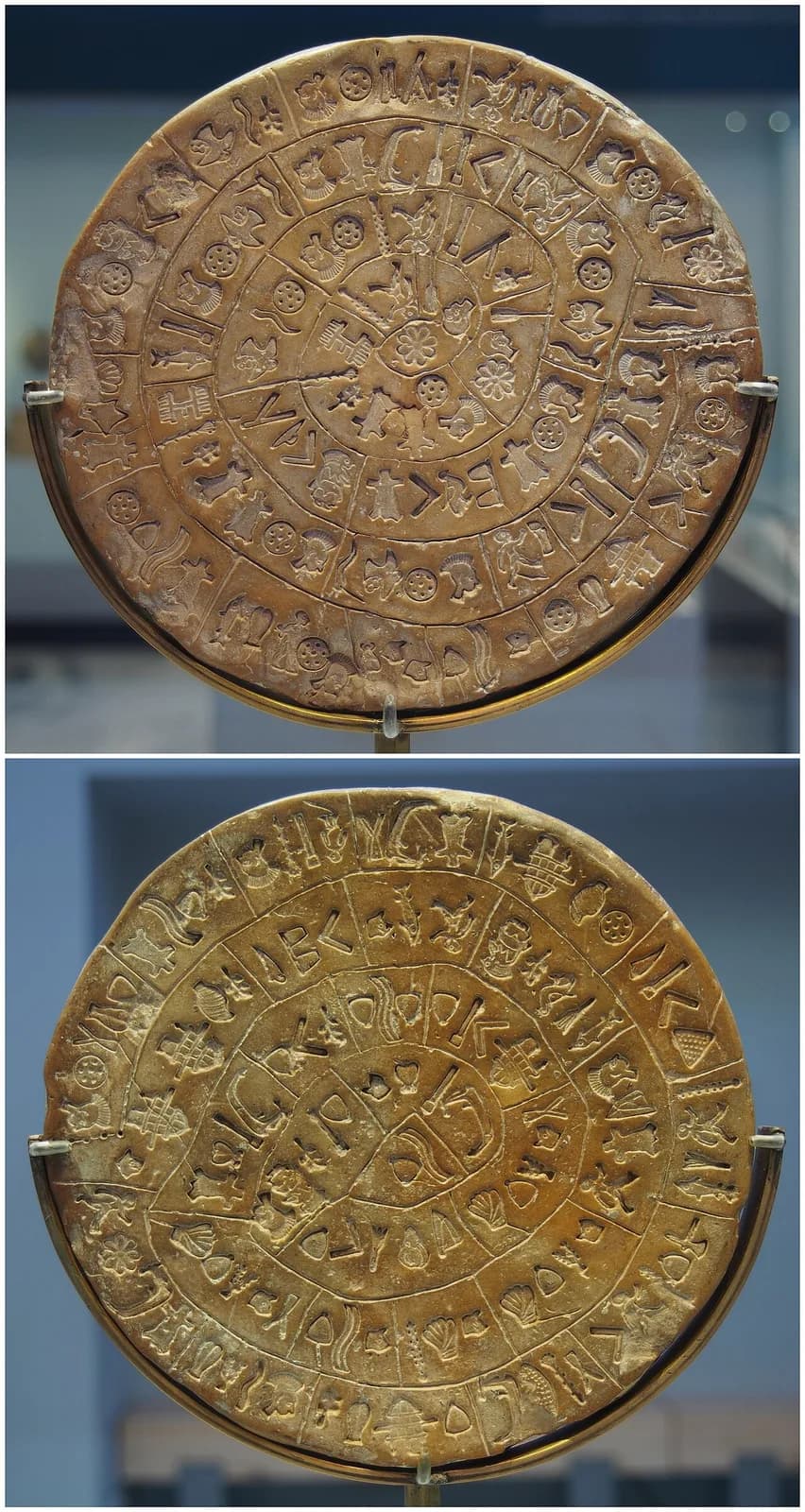 Two circular clay faces covered with impressed signs arranged in spirals.