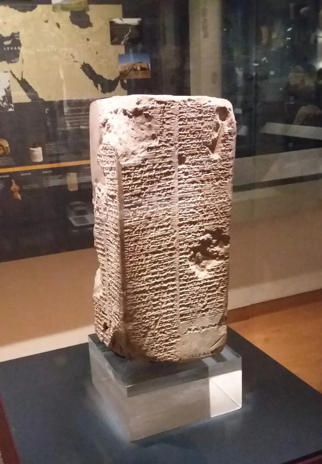 Four-sided clay prism densely inscribed with Sumerian cuneiform.